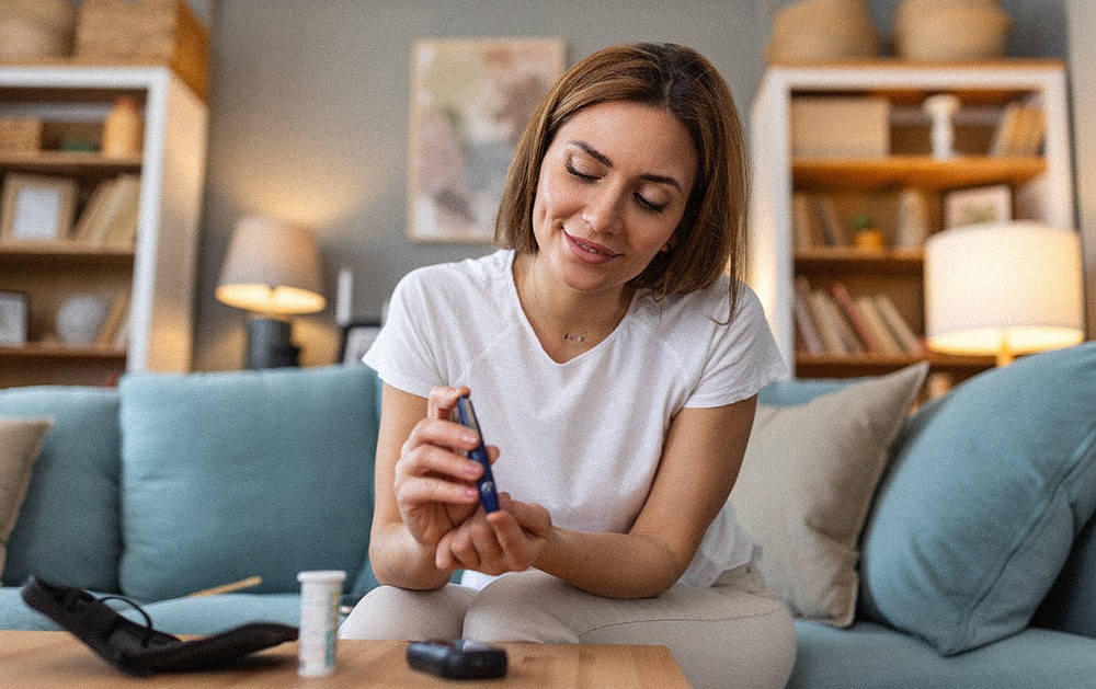 A young woman with diabetes doing an at-home blood sugar test with a glucometer.
